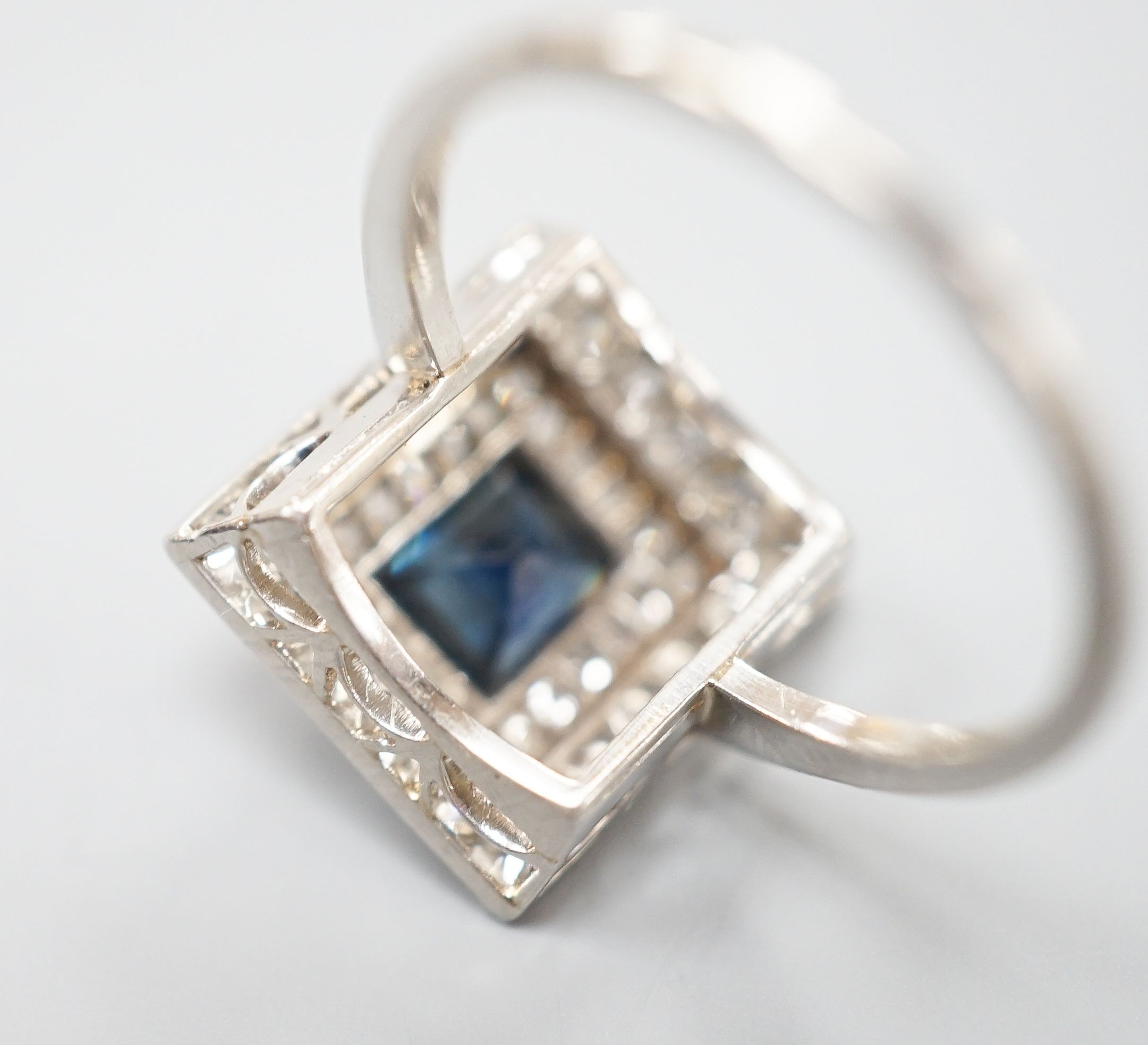 A white metal, sapphire and diamond set square cluster ring, size N, gross weight 4.2 grams.